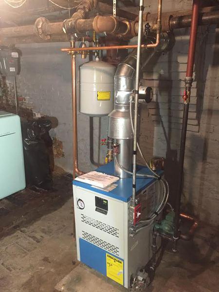 New boiler installation with copper piping and expansion tank